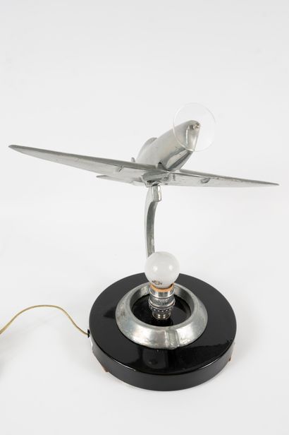 null Lamp formed by a glass globe surmounted by a metal airplane. 
Modern work. 
Height:...