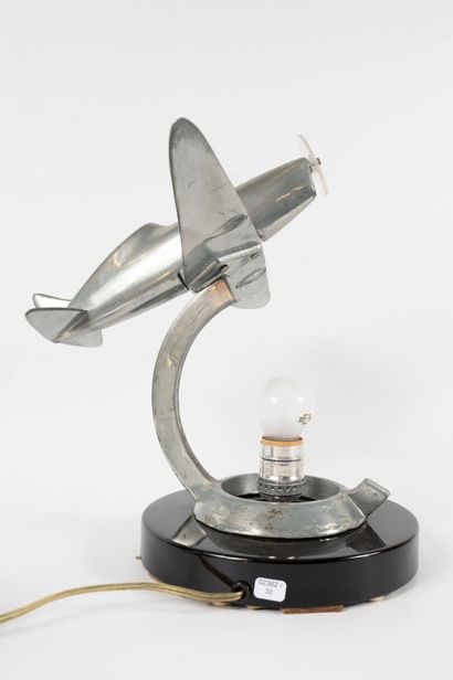 null Lamp formed by a glass globe surmounted by a metal airplane. 
Modern work. 
Height:...