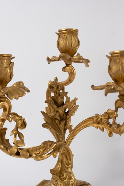 null A pair of ormolu candelabra with three moving light arms wrapped around a central...