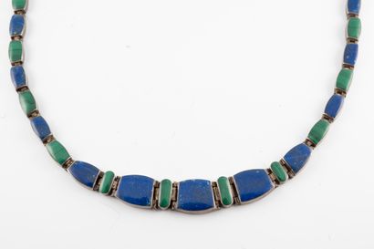 null Silver necklace adorned with alternating malachite and turquoise plaques. 
Gross...