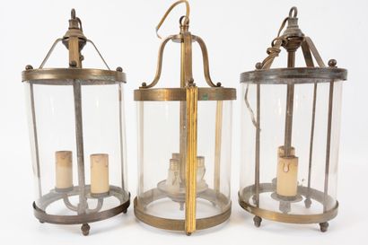 null Set of three brass and glass lanterns. 
Early 20th century
Height: approx. ...
