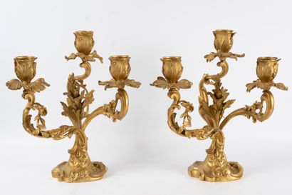 null A pair of ormolu candelabra with three moving light arms wrapped around a central...