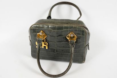 null Lot including:
- SONYA RYKIEL, Leather handbag 
- NINA RICCI, Small fabric clutch...