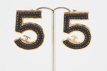null CHANEL, Circa 2023
Pair of gold-plated metal ear studs representing the number...