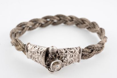 null Bracelet made of braided silver wires, the clasp chased with floral motifs and...