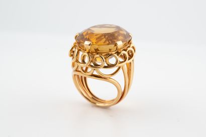 null 18k yellow gold Cocktail ring set with a large oval citrine weighing approx....