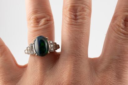 null 18k white gold ring set with a beautiful black opal with green and fire reflections...