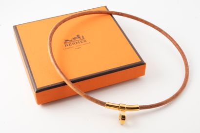 null HERMES, Paris
Natural leather choker with gilded metal clasp.
In original b...