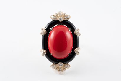 null 18k white gold ring set with a tinted coral cabochon in a line of onyx set with...