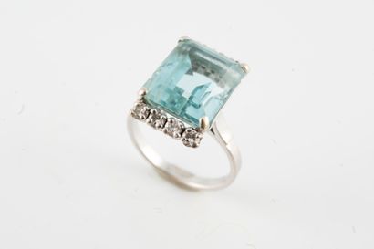 null 18k white gold ring set with an aquamarine weighing approx. 10cts flanked by...