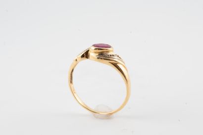 null 18k yellow gold ring surmounted by a ruby in a setting of small diamonds. 
Gross...