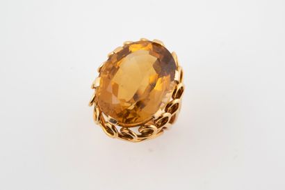 null 18k yellow gold Cocktail ring set with a large oval citrine weighing approx....