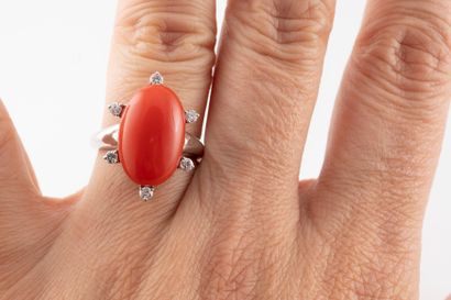 null 18k white gold ring centered with an oval coral cabochon surrounded by 6 diamonds.
Gross...