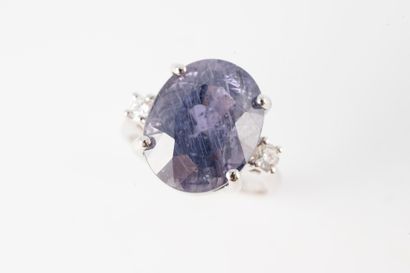 null 18k white gold ring set with a large natural Violet-purple sapphire weighing...