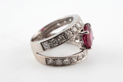 null 18k white gold ring centered with an oval ruby, approx. 2.50cts, between two...