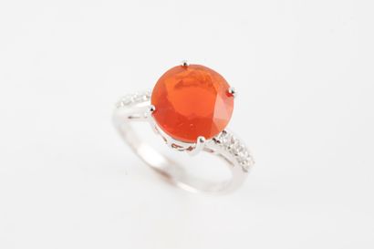 null 18k white gold ring centered on a round fire opal flanked by lines of diamonds.
Gross...