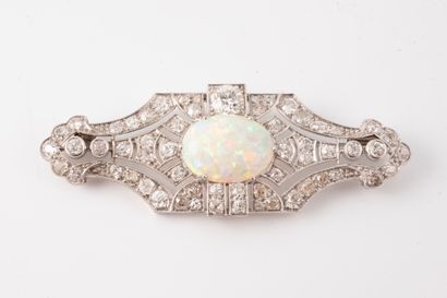 null Platinum brooch centered on an oval cabochon opal, approx. 4.50cts, set off...
