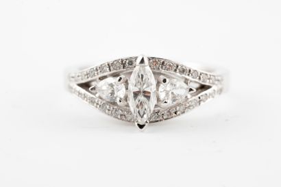 null 18k white gold ring centered with a 0.30ct navette-cut diamond flanked by two...