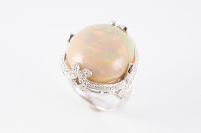 null Important 18k white gold ring set with a round opal cabochon on a finely worked...