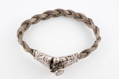 null Bracelet made of braided silver wires, the clasp chased with floral motifs and...