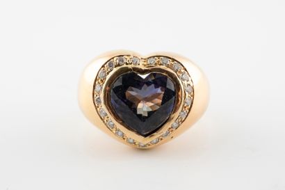 null 18k yellow gold ring set with a large heart-cut tanzanite in a diamond setting....