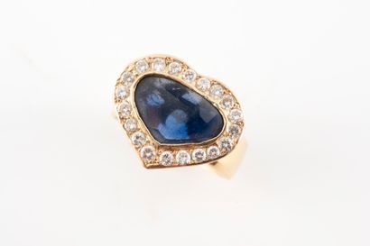 null 18k yellow gold ring surmounted by a heart-cut sapphire in a diamond setting....