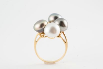 null 18k yellow gold ring adorned with four cultured pearls, three Tahitian and one...