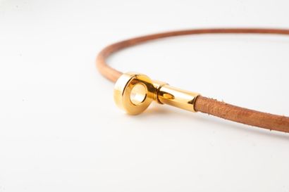 null HERMES, Paris
Natural leather choker with gilded metal clasp.
In original b...