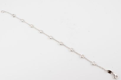 null 18k white gold bracelet holding 9 diamonds in a closed setting totaling approx....