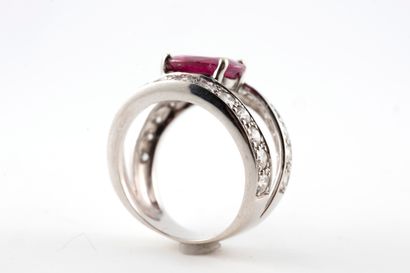 null 18k white gold ring centered with an oval ruby, approx. 2.50cts, between two...