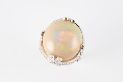 null Important 18k white gold ring set with a round opal cabochon on a finely worked...