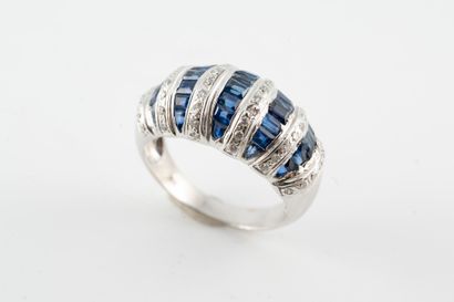 null 18k white gold dome ring set with 5 lines of calibrated sapphires alternating...