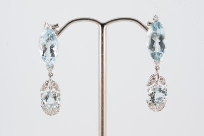 null Pair of 18k white gold earrings holding round and navette-cut aquamarines set...