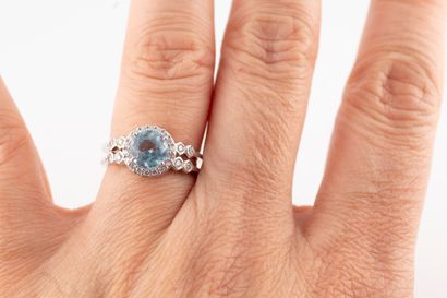 null 18k white gold ring set with a round topaz in a diamond setting. The two-row...