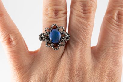 null Flower ring in 18k rhodium-plated white gold, centered on a black opal, within...