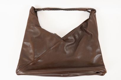 null BOTTEGA VENETA
A brown leather bag with a braided leather handle and a small...