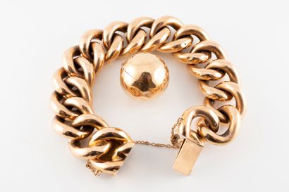 null 18k yellow gold supple bracelet with large curb chain holding a spherical 18k...
