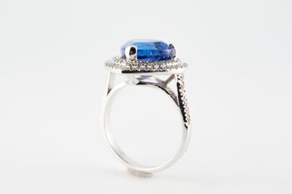 null 18k white gold ring set with a large 5.94cts intense Violetish blue pear-cut...