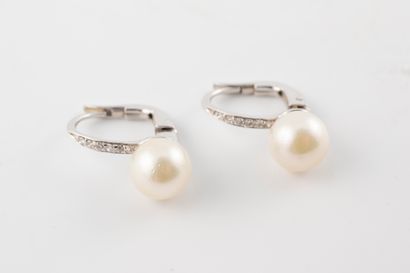 null Pair of 18k white gold earrings set with 6mm cultured pearls, the hoop topped...