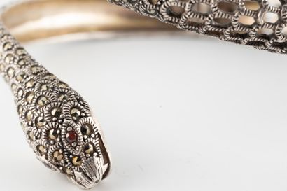 null Openwork silver bangle representing a coiled snake entirely set with marcasites.
Gross...