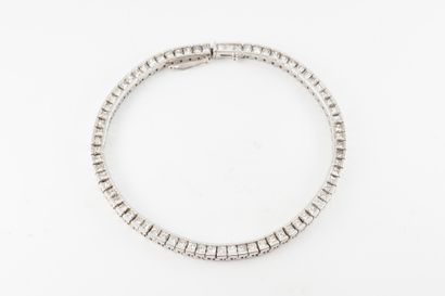null 18k white gold rivière souple bracelet set with 74 princess-cut diamonds, approx....