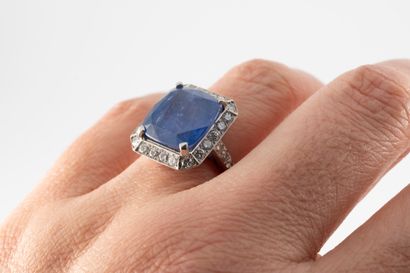 null 18k white gold ring centered on a large cushion-cut sapphire weighing 12.89...