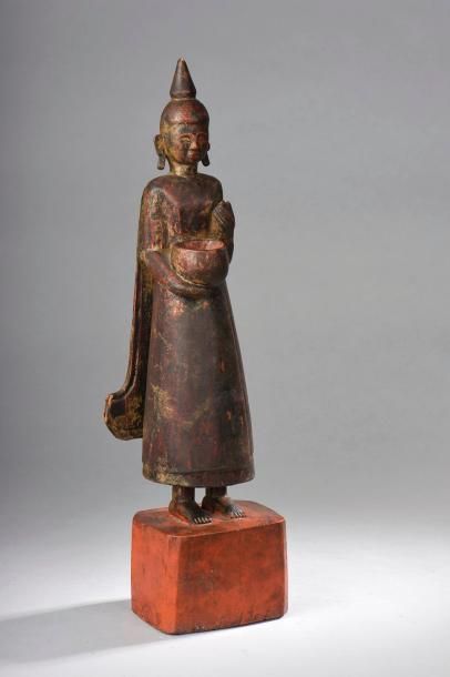 null Buddha debout sur un tertre quadrangulaire vêtu de la robe monastique stylisée...