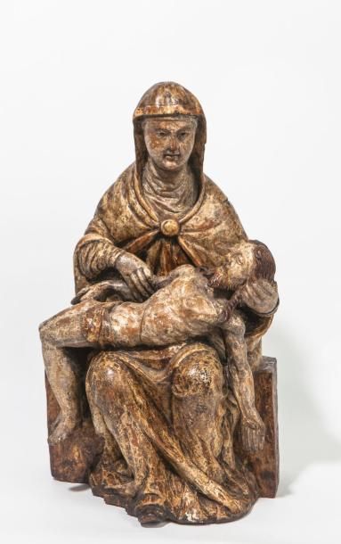 null Belle Piéta sculptée en bois polychrome. Assise sur un banc, la Vierge porte...