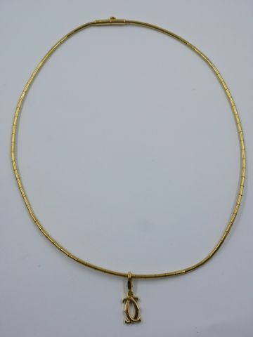 null CARTIER. Collier en or jaune 18k agrémenté d'un pendentif "C", signé, numéroté...