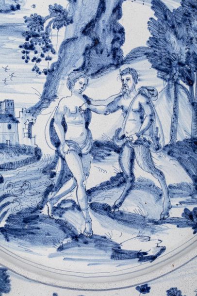 null Grand plat en faience à décor mythologique d'Adam et Eve en bleu sur fond blanc,...