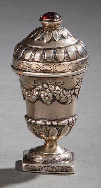 null Silver scent box in the shape of a medicis vase. The lid is set with a red stone.
Foreign...