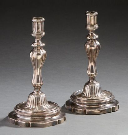 null Pair of silver candlesticks with canals and gadroons decoration on an animated...