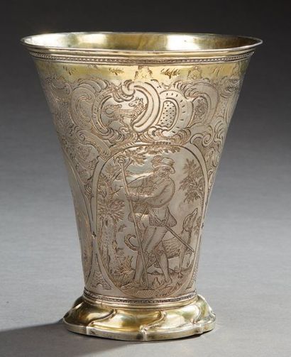 null Large silver and vermeil goblet of flared shape on a pedestal with torsos ribs....