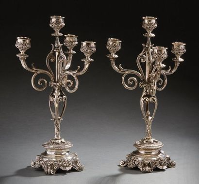 null Pair of four-light candelabra in silver, the base resting on four winding legs...